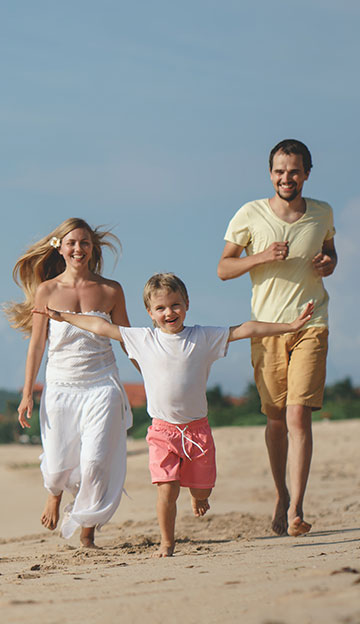 happy family running on beach 